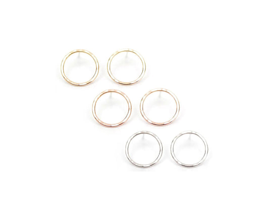 a collection of six circular earrings, each with a unique color and design, arranged in two rows of three.