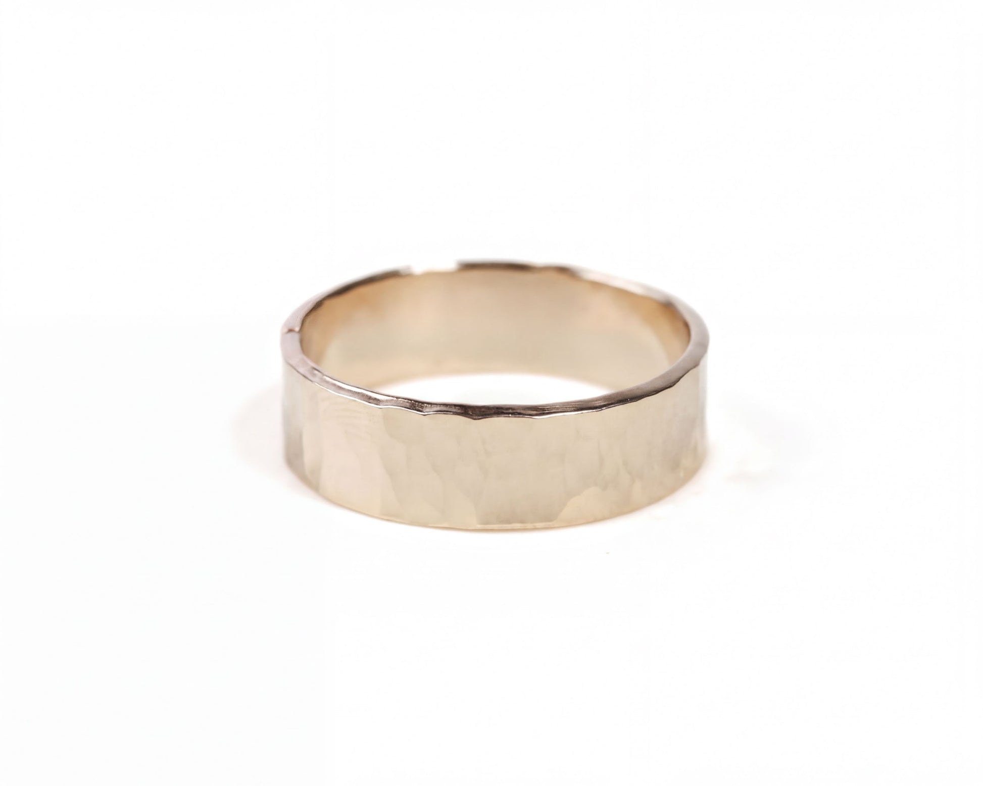 A simple gold ring with a smooth, shiny surface.