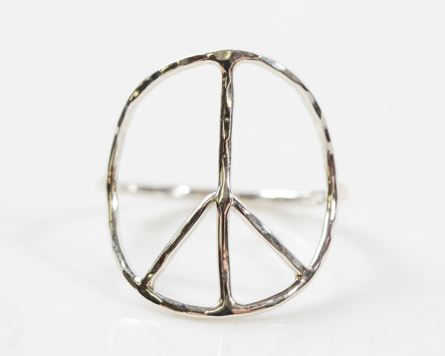 A silver ring in the shape of a peace symbol.