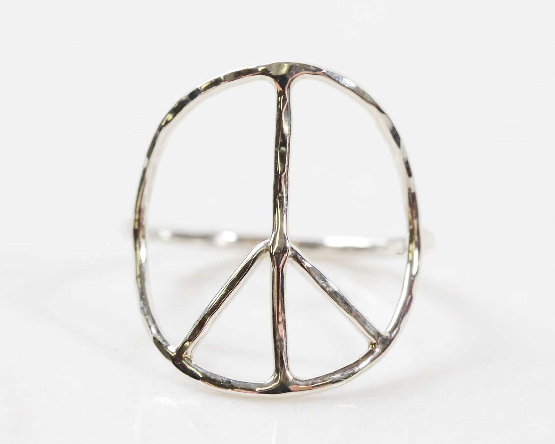 A silver ring in the shape of a peace symbol.