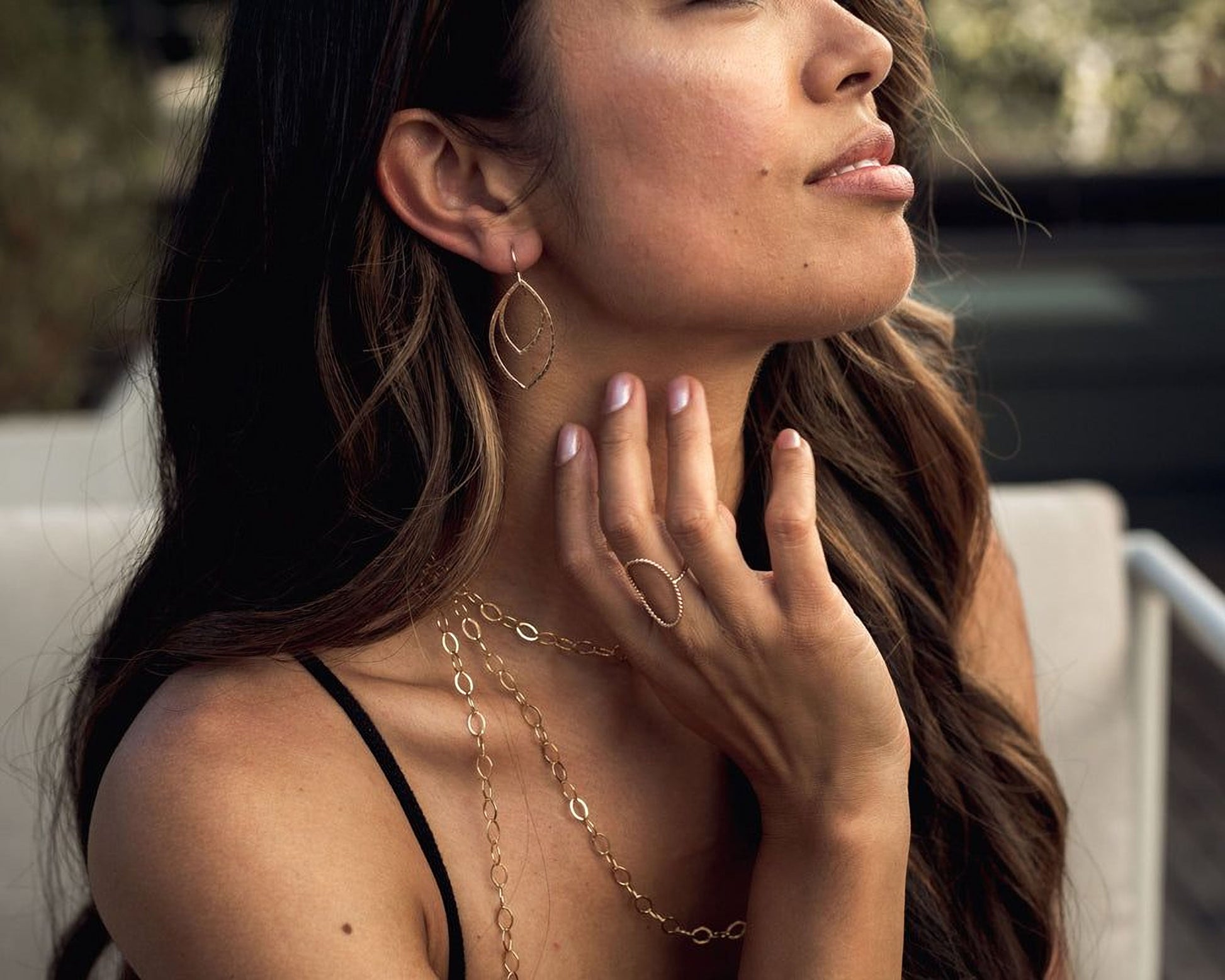 Model is wearing the all gold format. Two delicately handcrafted leaf shapes sway together beneath 14 karat gold filled ear wires. Their texture subtly suggests the veins of a leaf. Handmade, each earring is 2 inches and the design is minimalist.