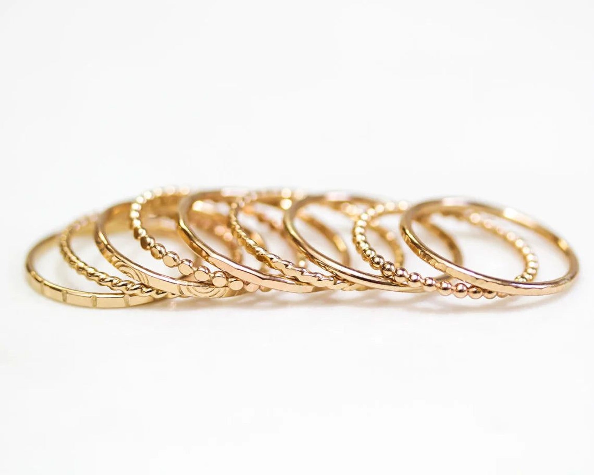 A row of gold-colored rings with a metallic texture, arranged in a visually appealing manner.