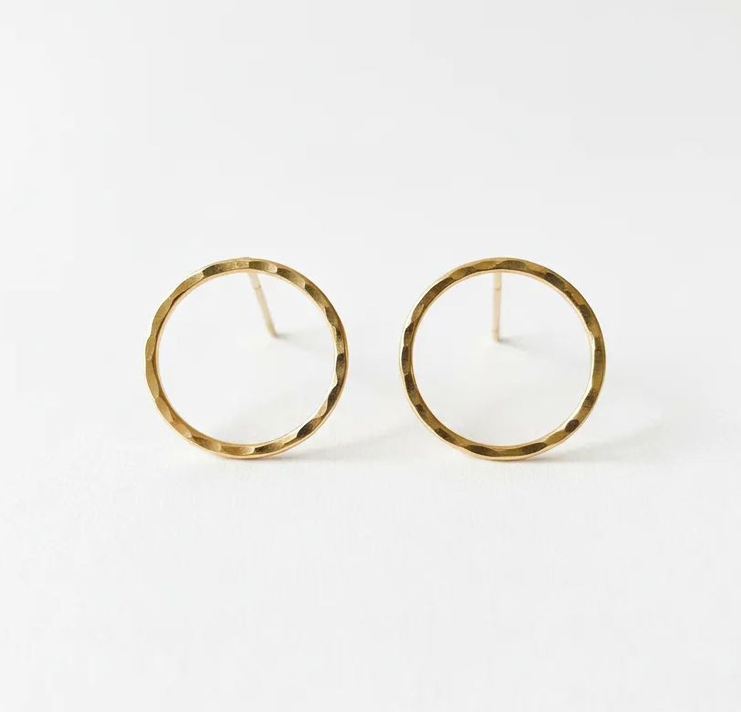 A pair of gold-colored earrings with a simple, elegant design.