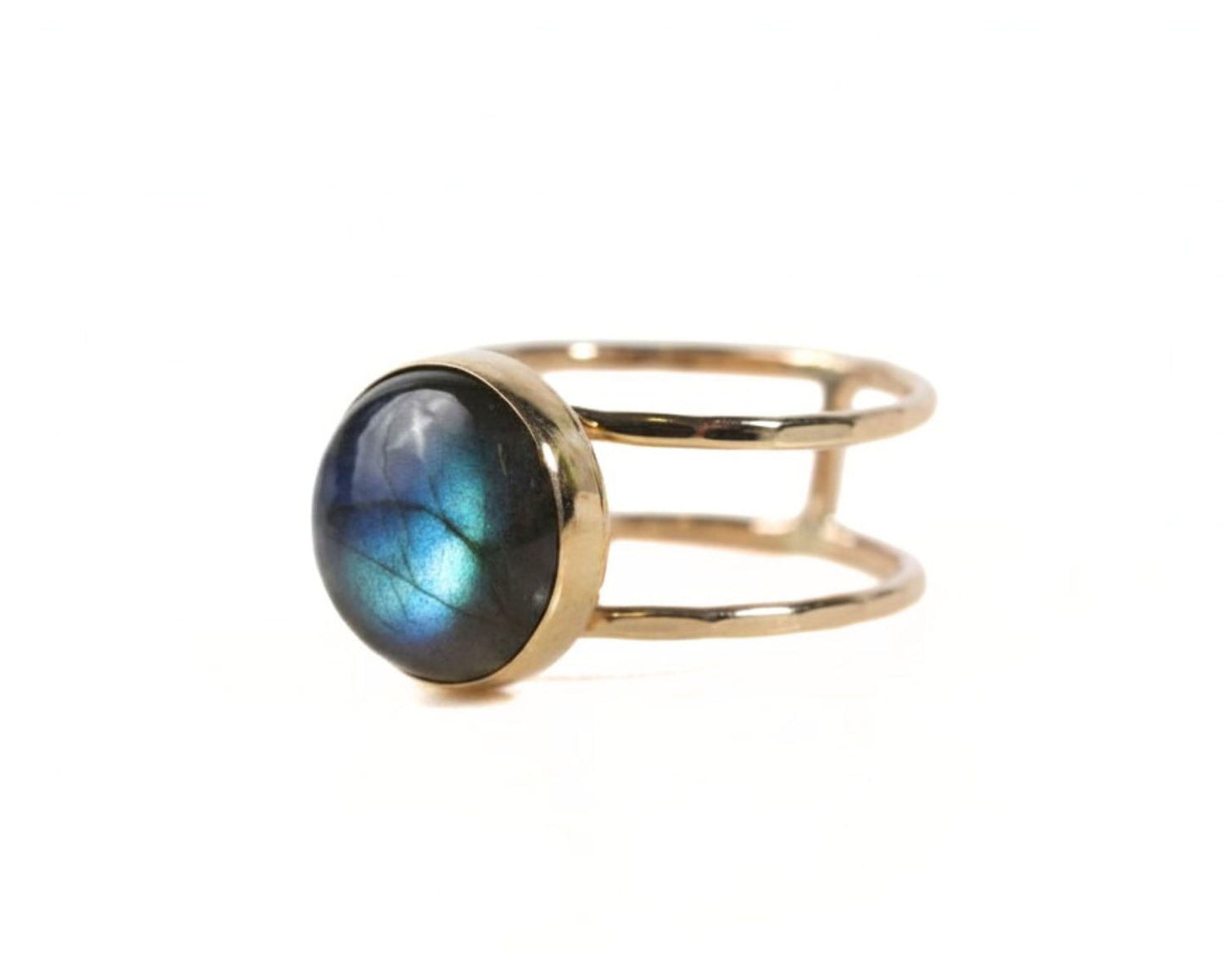 A gold ring with a blue gemstone, likely a lapis lazuli, set in a double band.