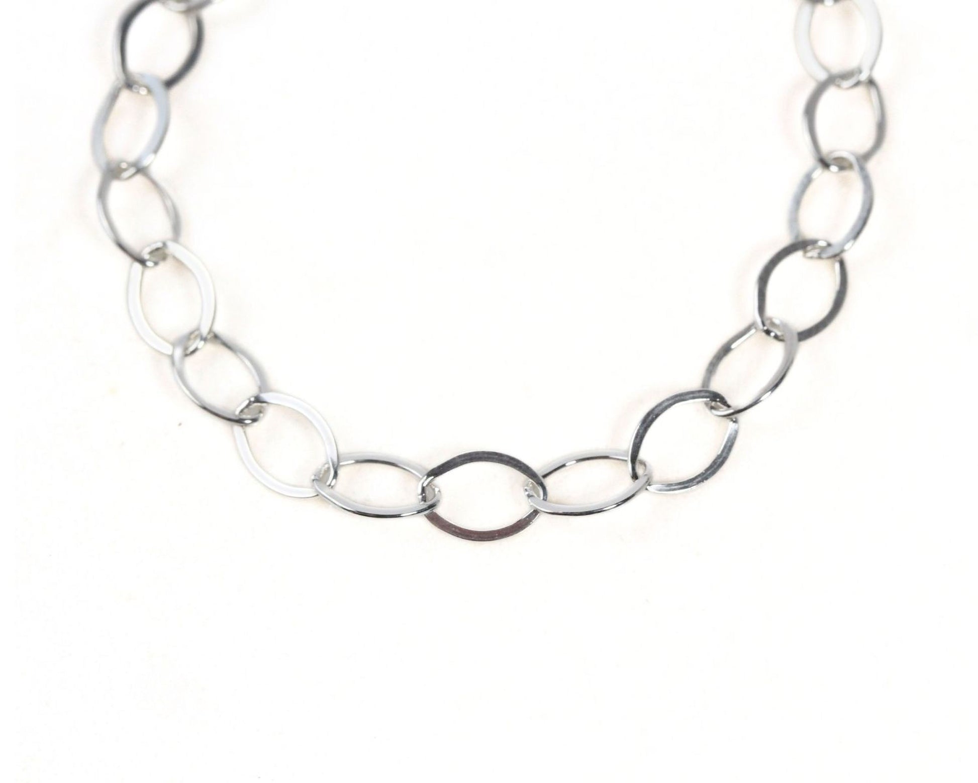 A silver chain necklace with multiple interlocking links.