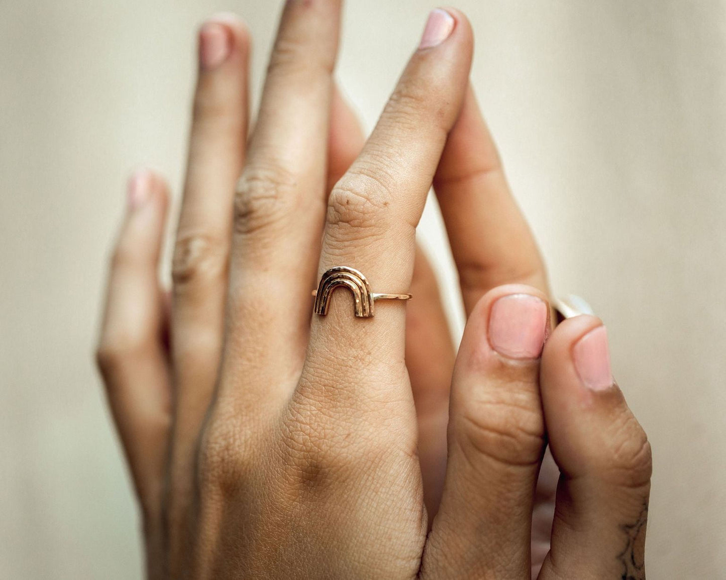 Photo showcases mini 14 karat gold filled handmade and handcrafted rainbow ring on finger. Delicate, tiny, meaningful. Gift for hope, gift for her. The rainbow is hammered for a twinkling texture. Offered in US Ring Sizes. All handmade in USA.