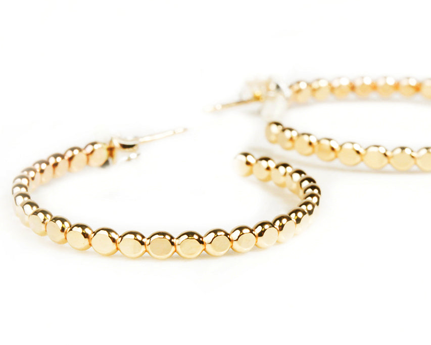 Each element of our Beaded Ivy Hoop Earrings is handcrafted to perfection, from their gleaming fine metal materials to their simple yet impactful design. They are perfect for everyday wear. Shown here in 14 karat yellow gold filled.