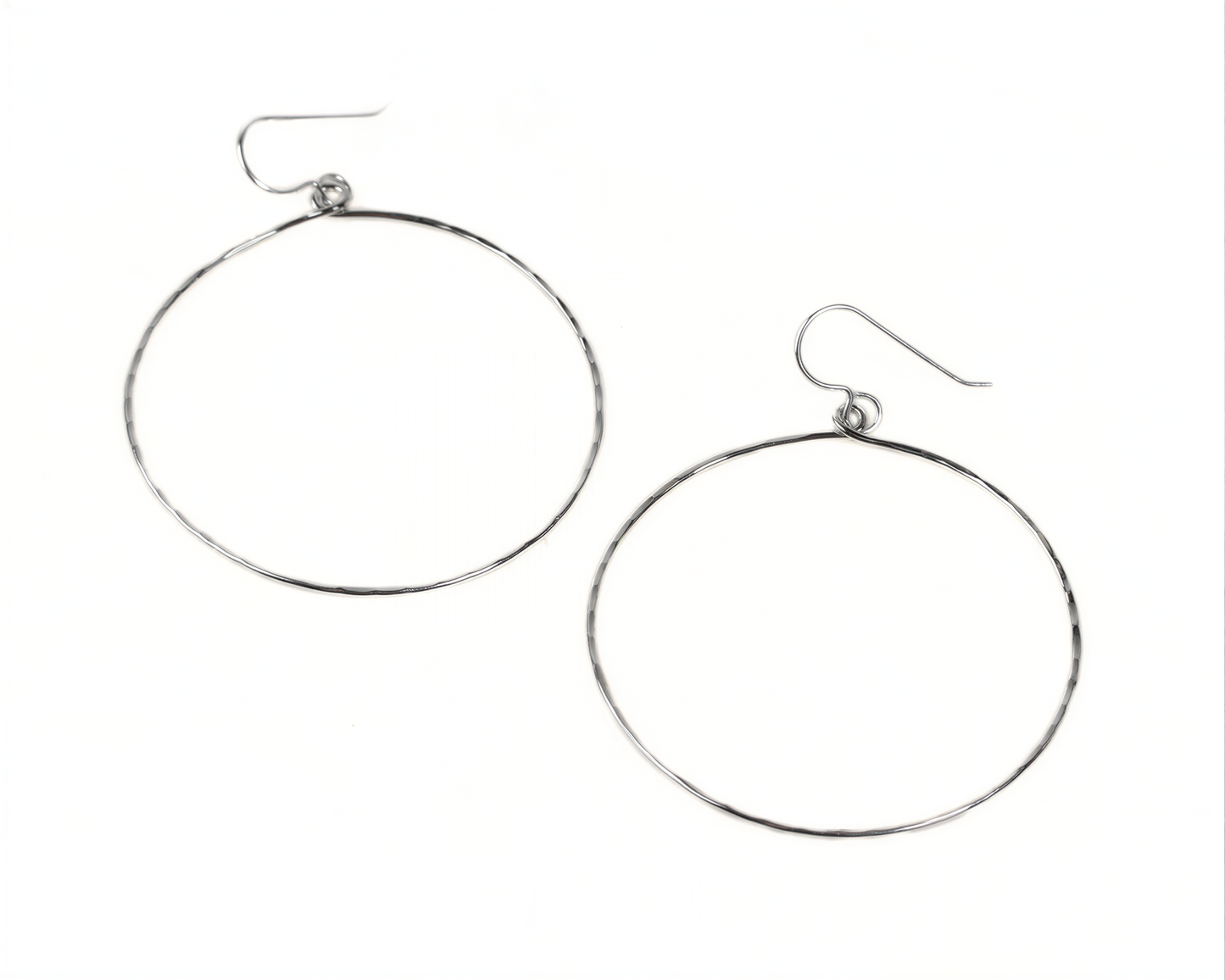 A pair of silver hoop earrings with a simple design.