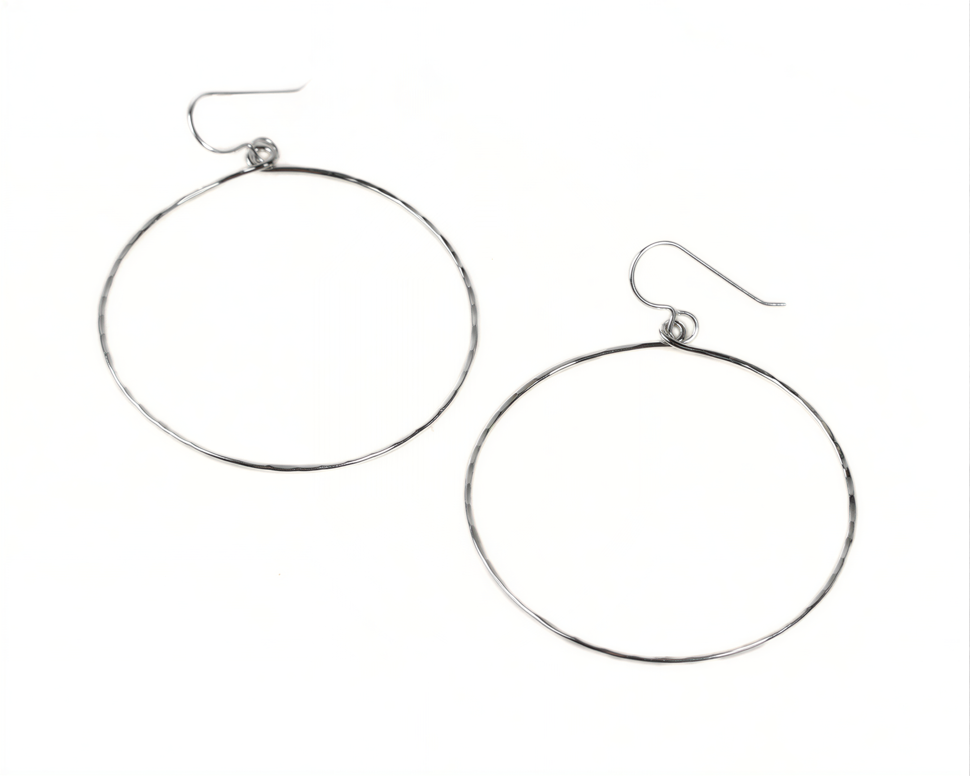 A pair of silver hoop earrings with a simple design.