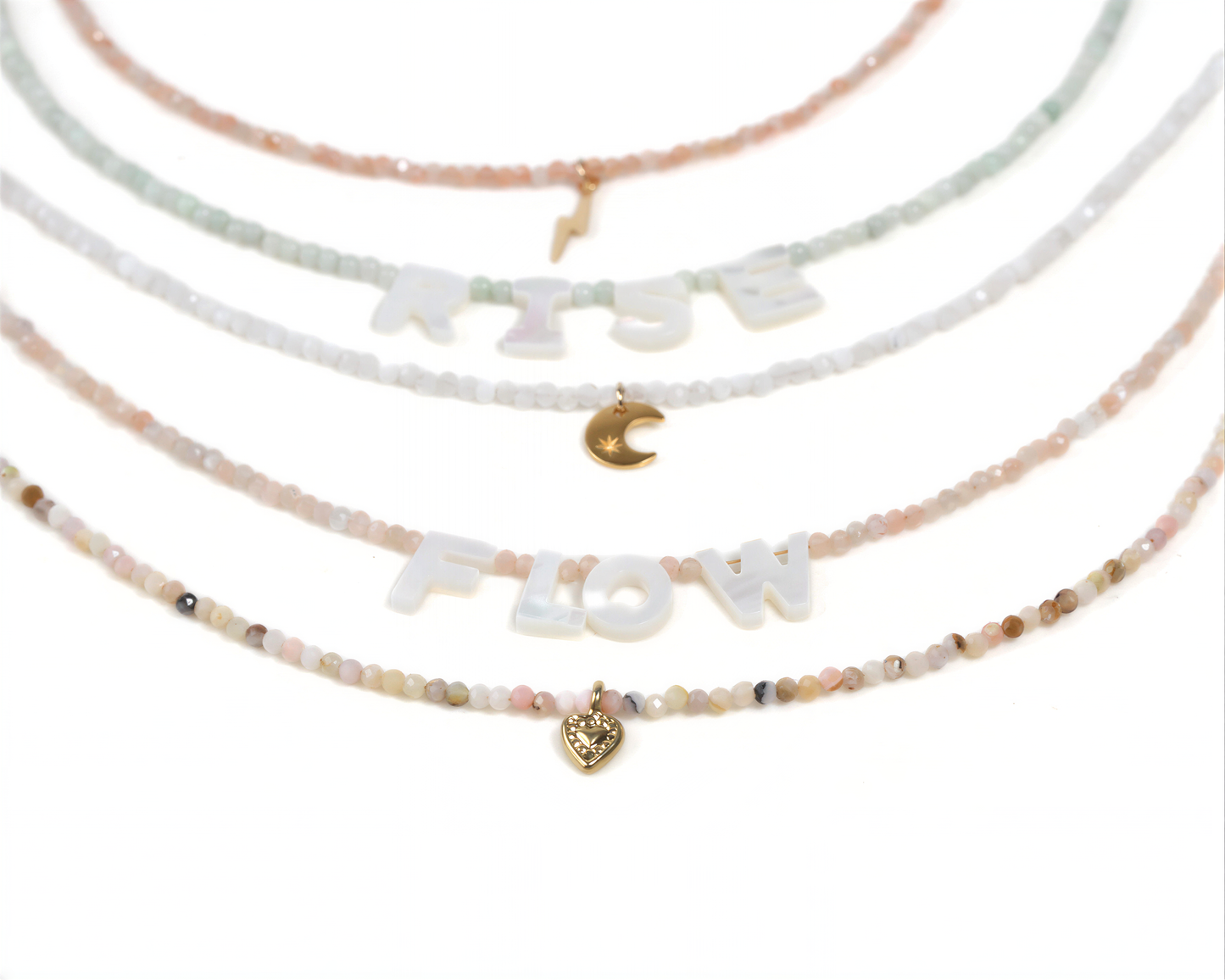 A collection of beaded necklaces with the word "FLOW" spelled out in large letters, along with a small heart charm.