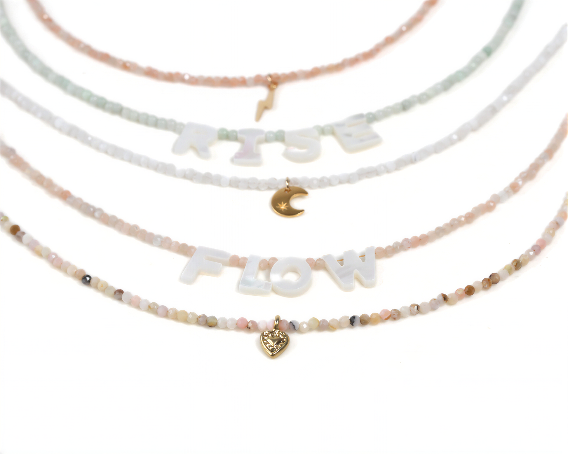 A collection of beaded necklaces with the word "FLOW" spelled out in large letters, along with a small heart charm.