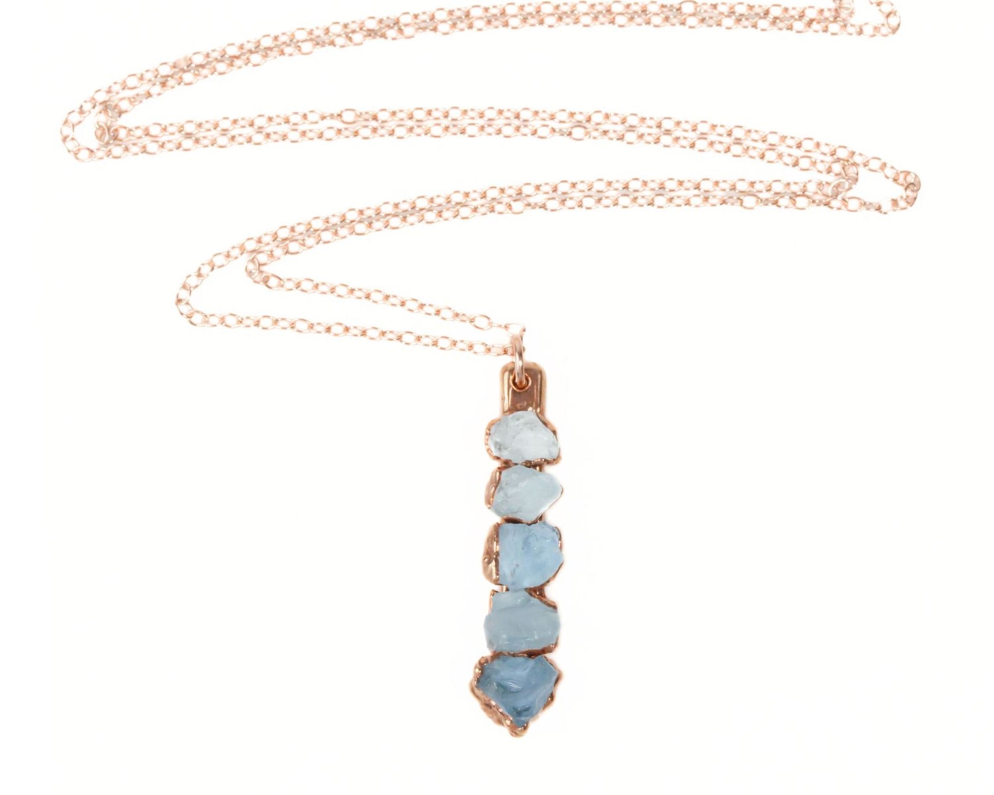A necklace with a pendant featuring a row of blue gemstones.