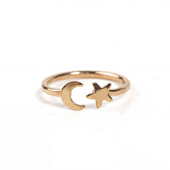 Our Lunara Sky Ring displays a dainty crescent moon that sits opposite an equally dainty five-pointed star in this open style celestial wraparound ring.