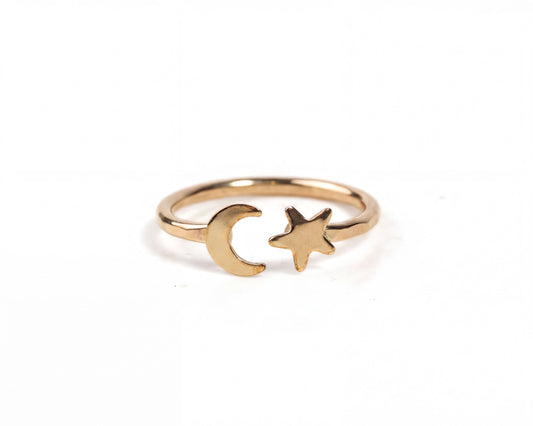 Our Lunara Sky Ring displays a dainty crescent moon that sits opposite an equally dainty five-pointed star in this open style celestial wraparound ring.