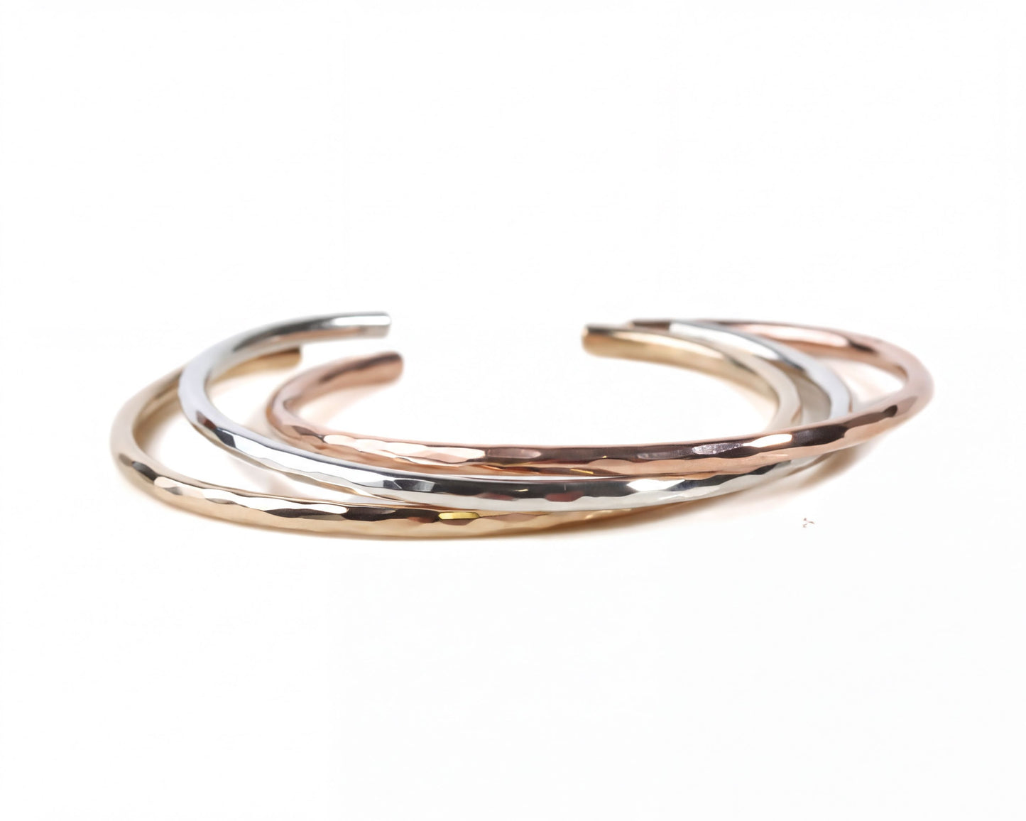 A group of three bracelets with different colors and textures, arranged in a circular pattern.