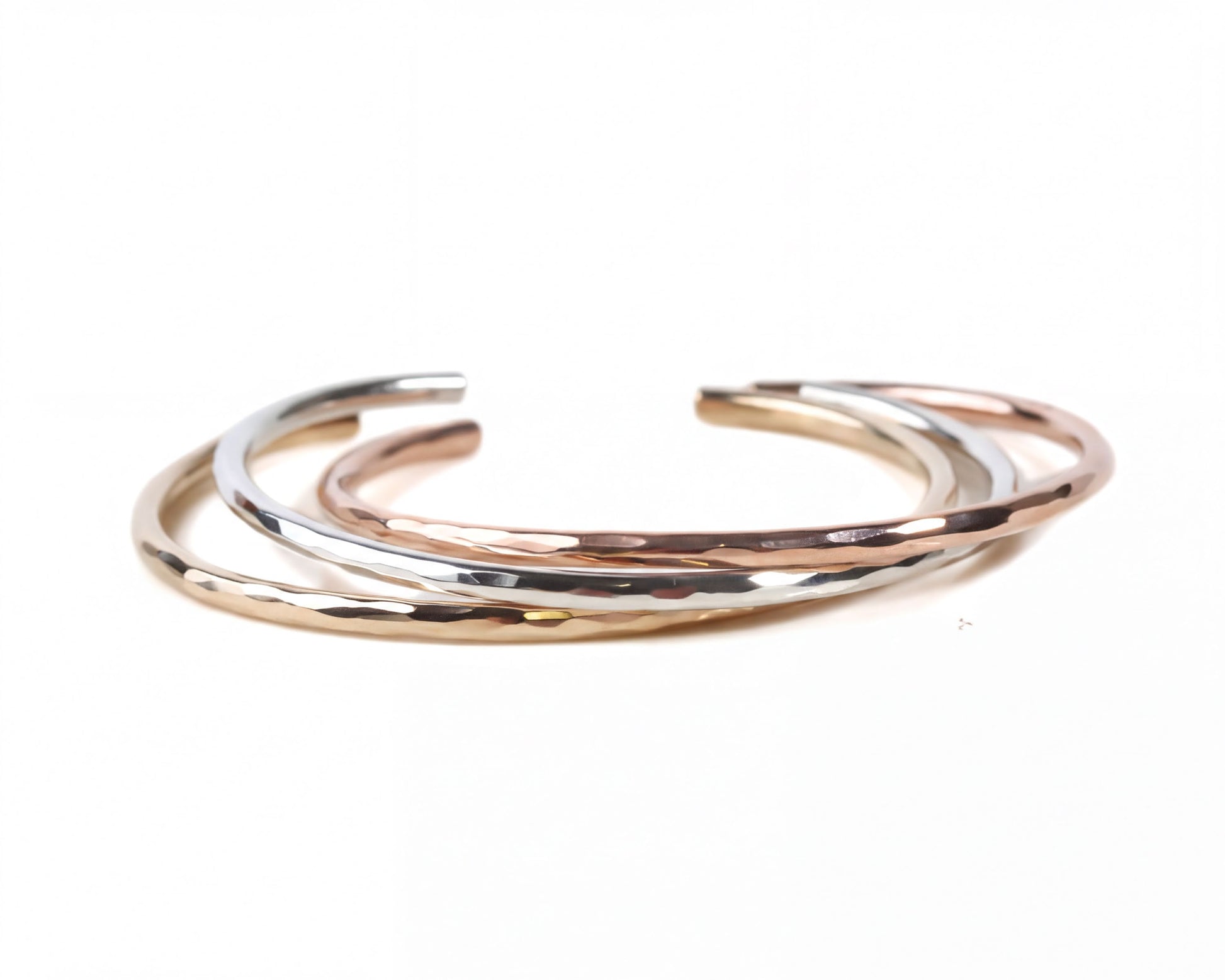 A group of three bracelets with different colors and textures, arranged in a circular pattern.