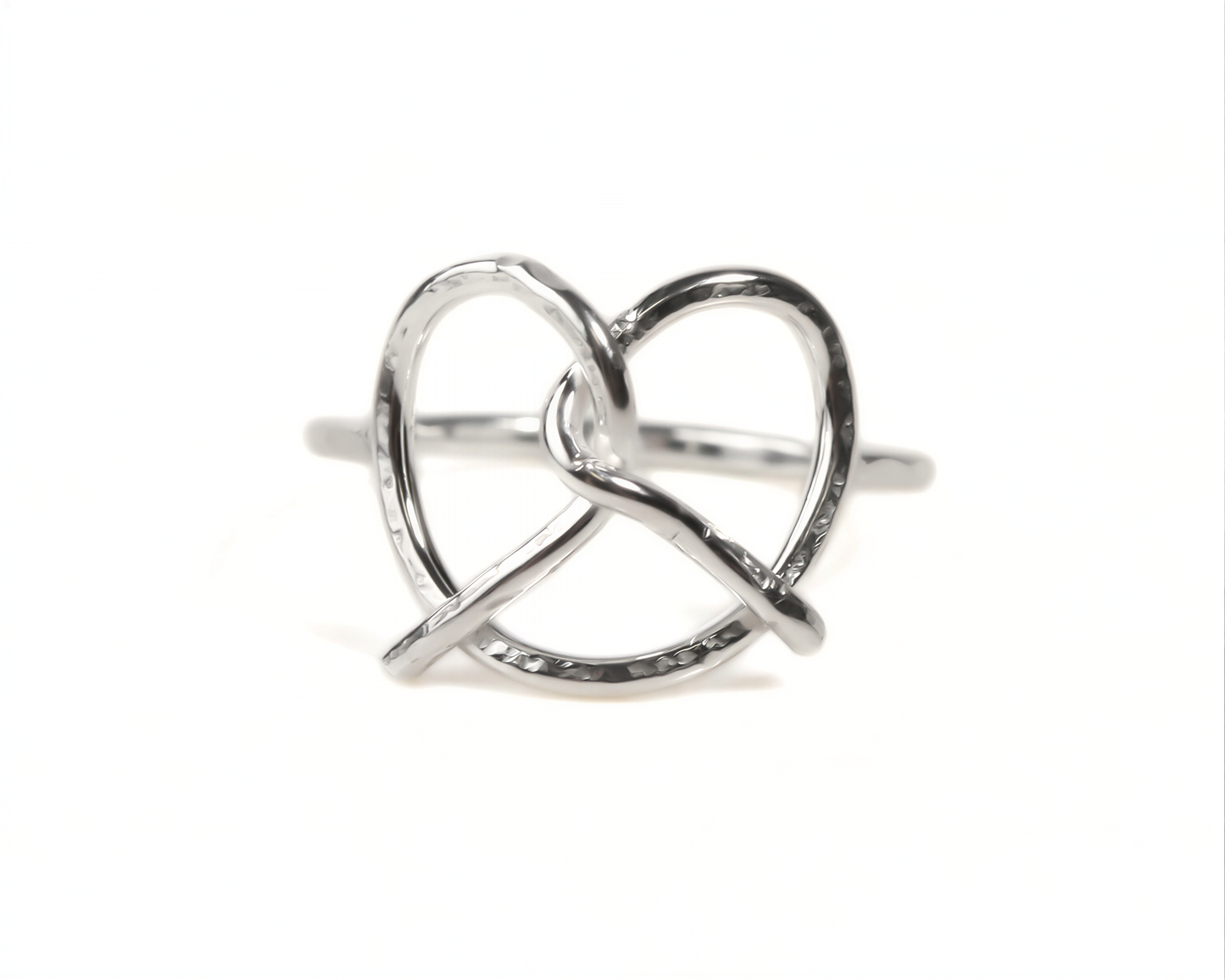 A silver ring with a twisted, heart-shaped design.