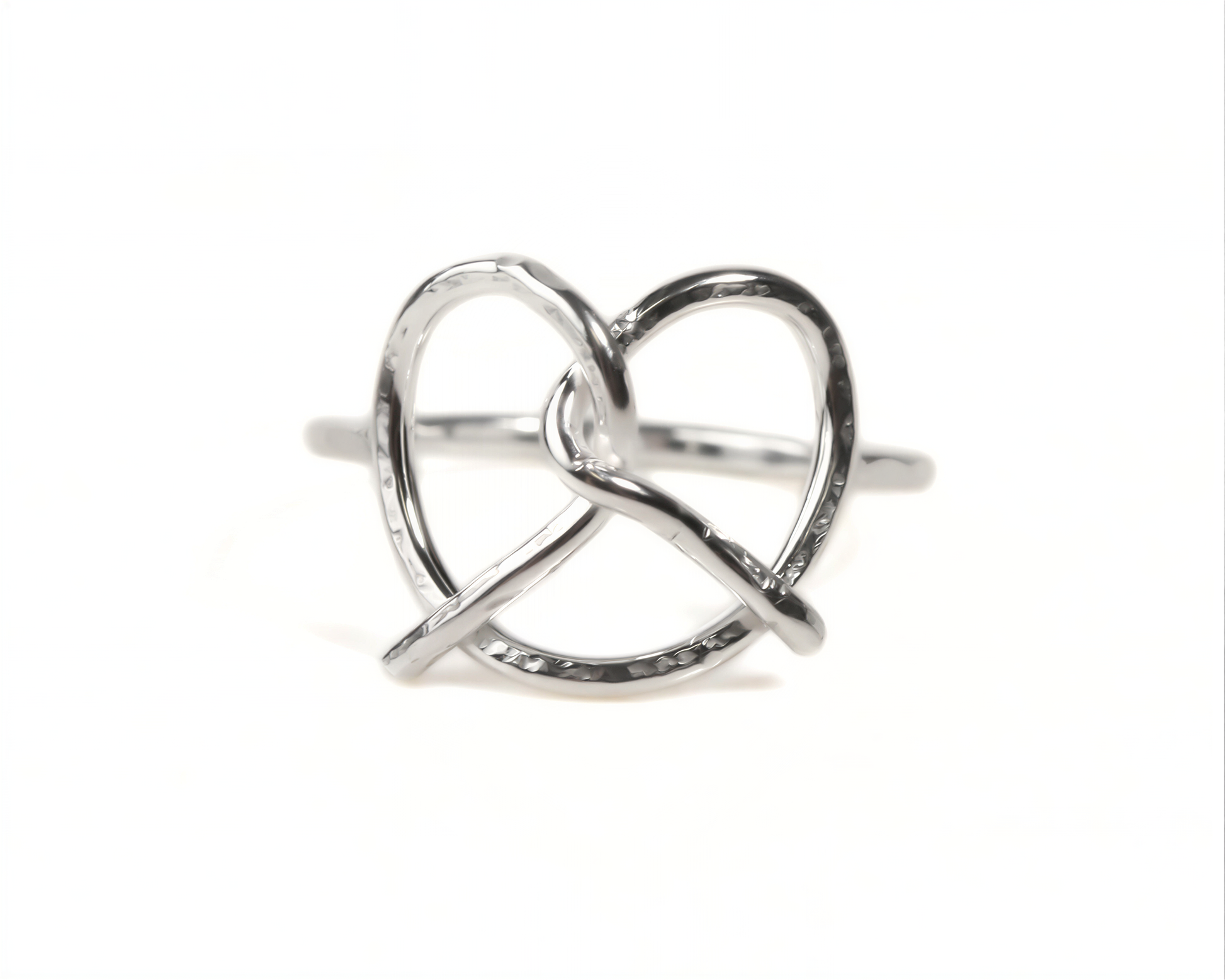 A silver ring with a twisted, heart-shaped design.