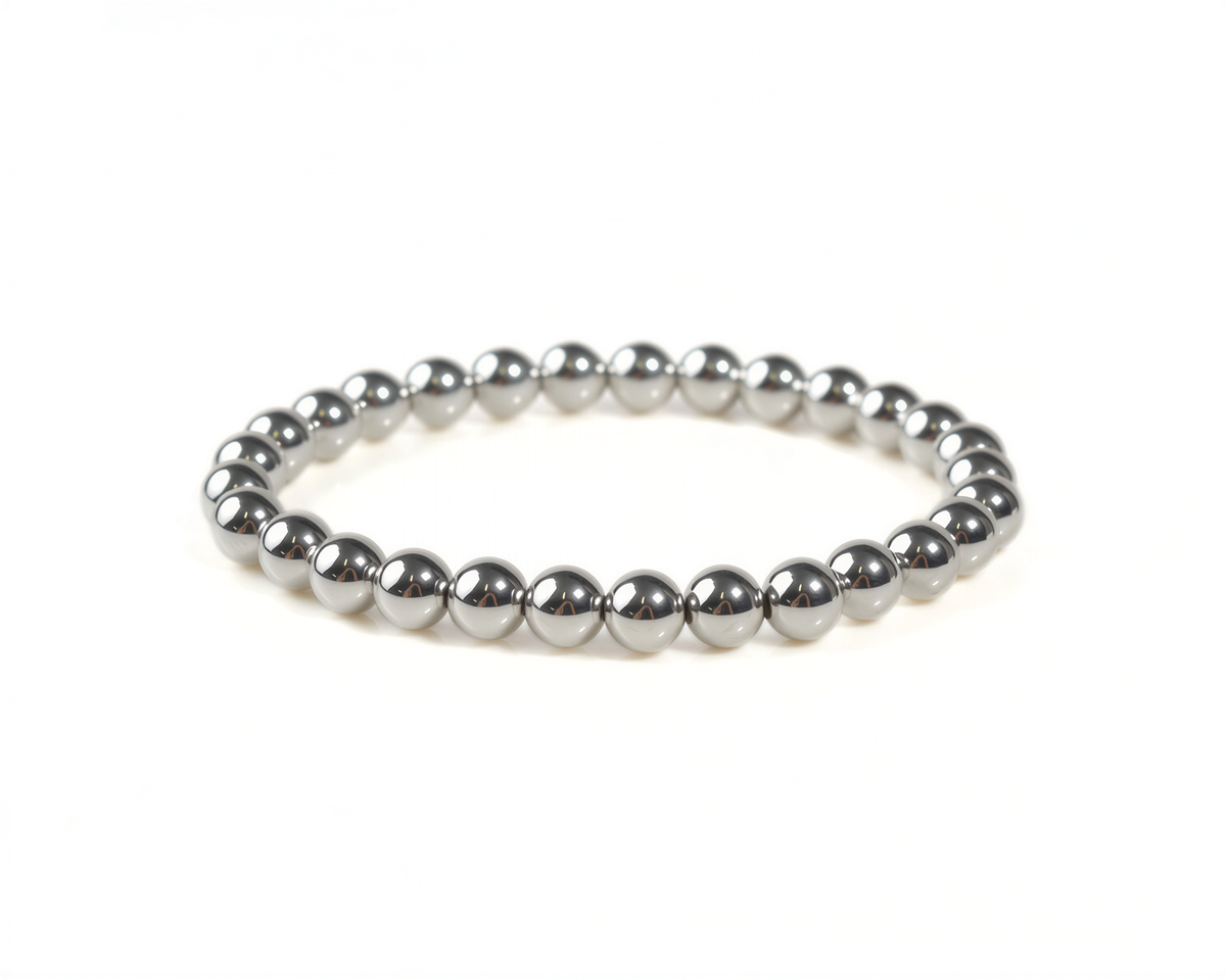 A silver-colored bracelet composed of numerous small, shiny beads arranged in a circular pattern.