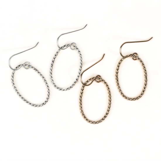 a pair of earrings with twisted metal designs, featuring two pairs of earrings in different colors.