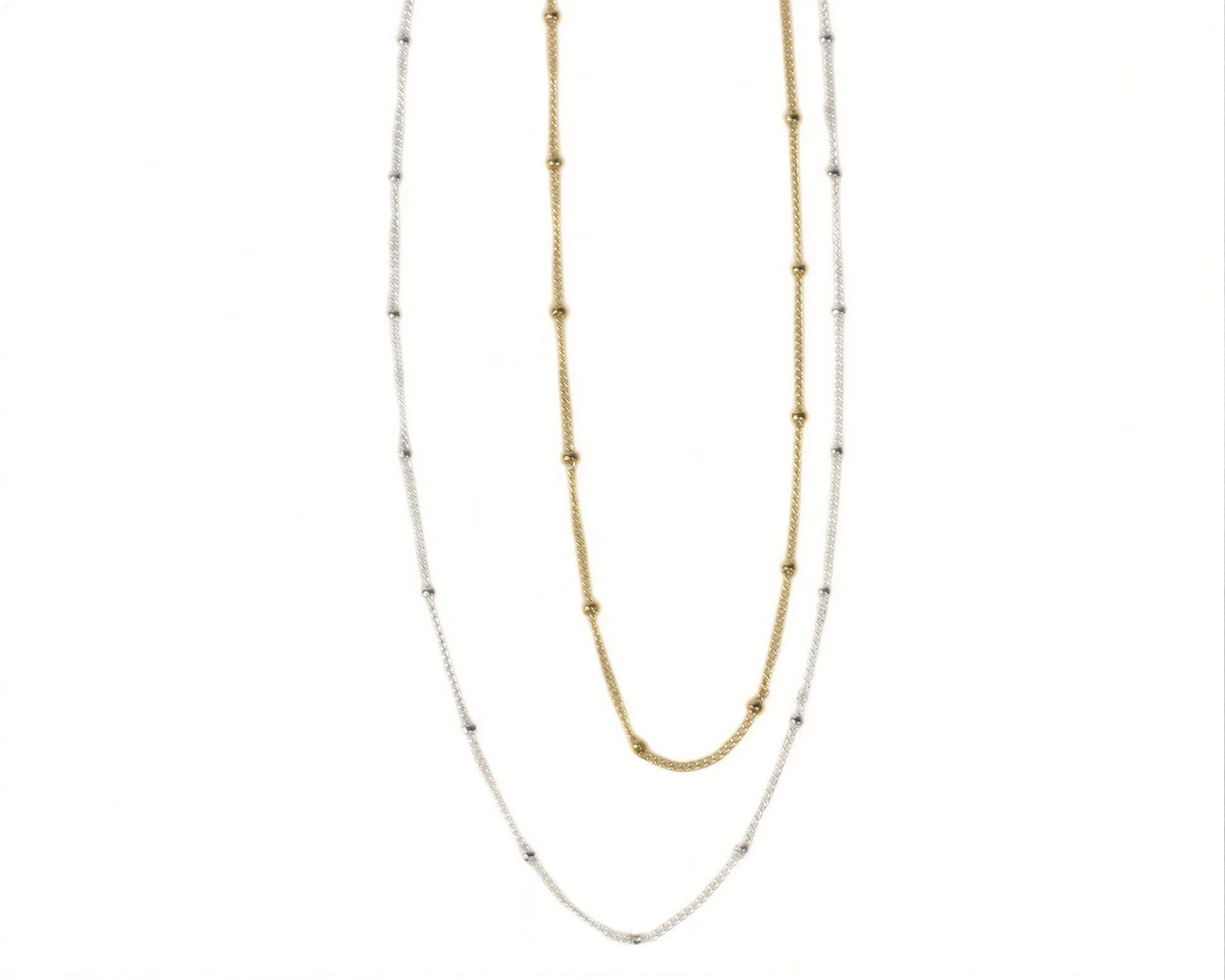 two necklaces, one silver and one gold, with small beads on the chains.
