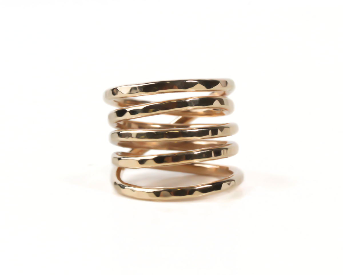 A gold ring with a spiral design, showcasing the intricate details and craftsmanship of the piece.