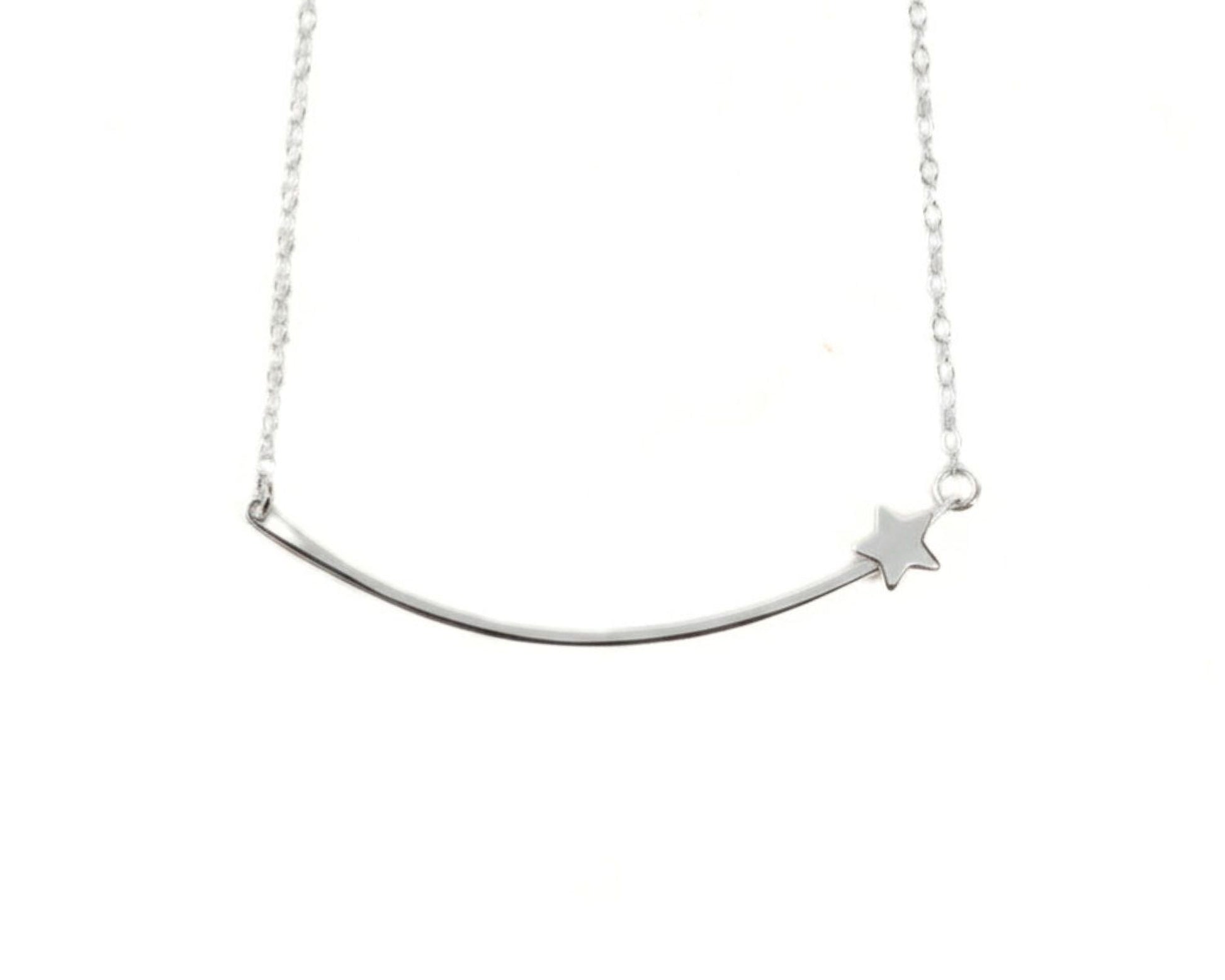 A silver necklace with a curved bar and a small star charm.