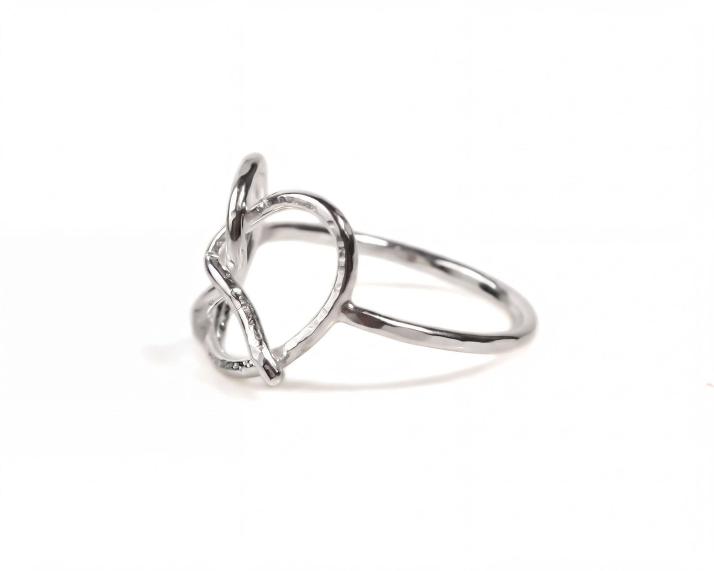 A silver ring with a heart-shaped design.
