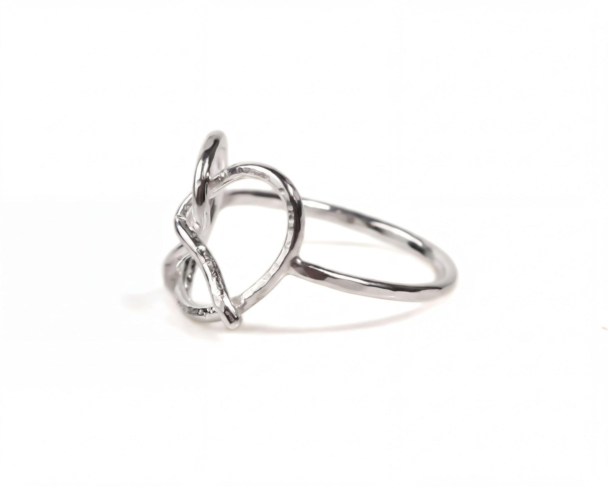 A silver ring with a heart-shaped design.