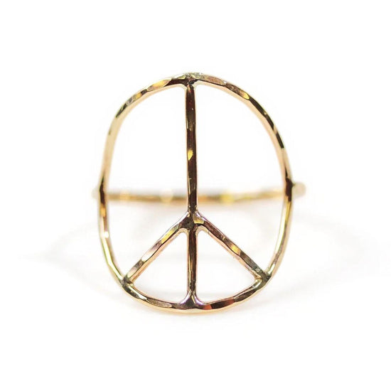 A gold ring in the shape of a peace symbol.