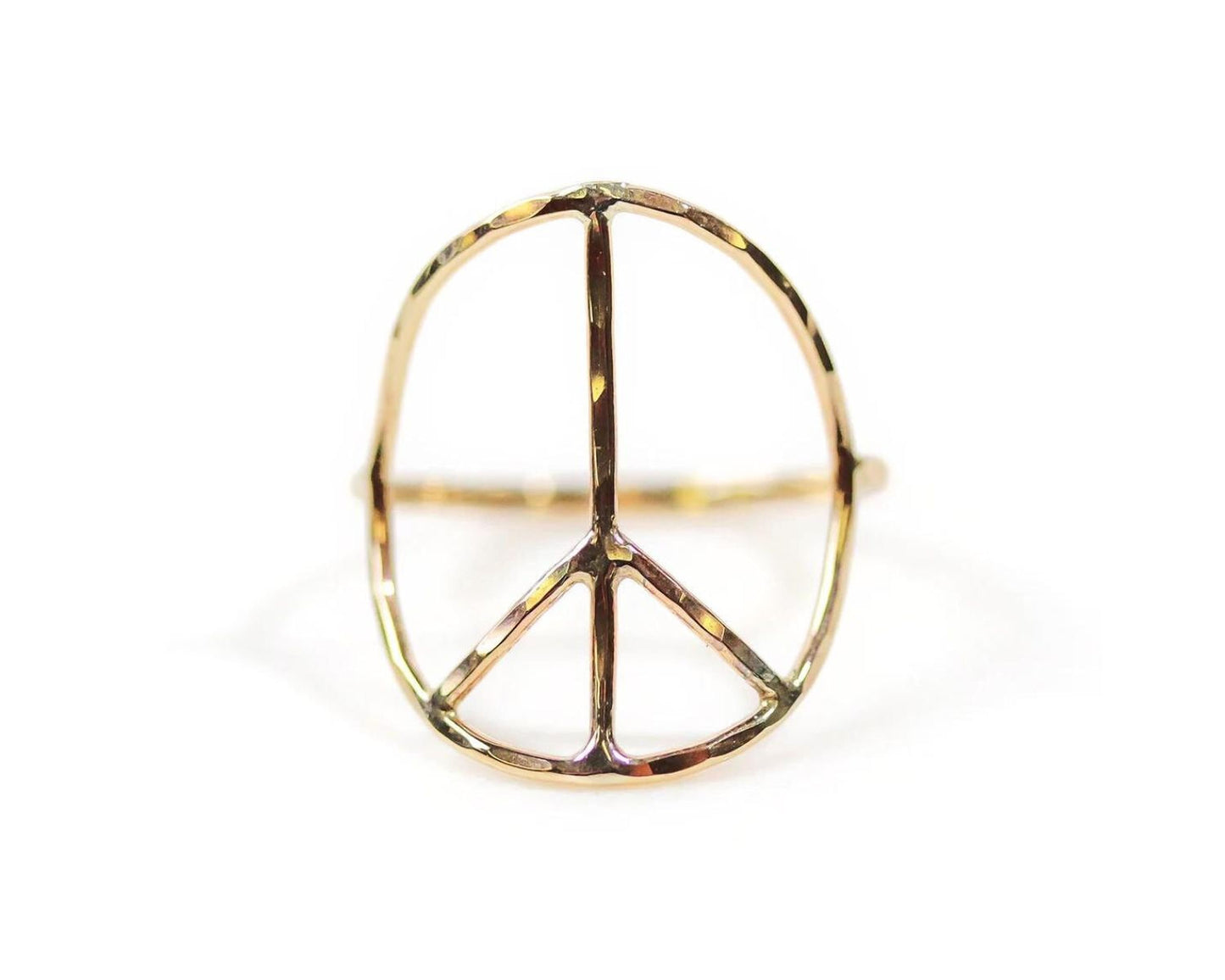 A gold ring in the shape of a peace symbol.