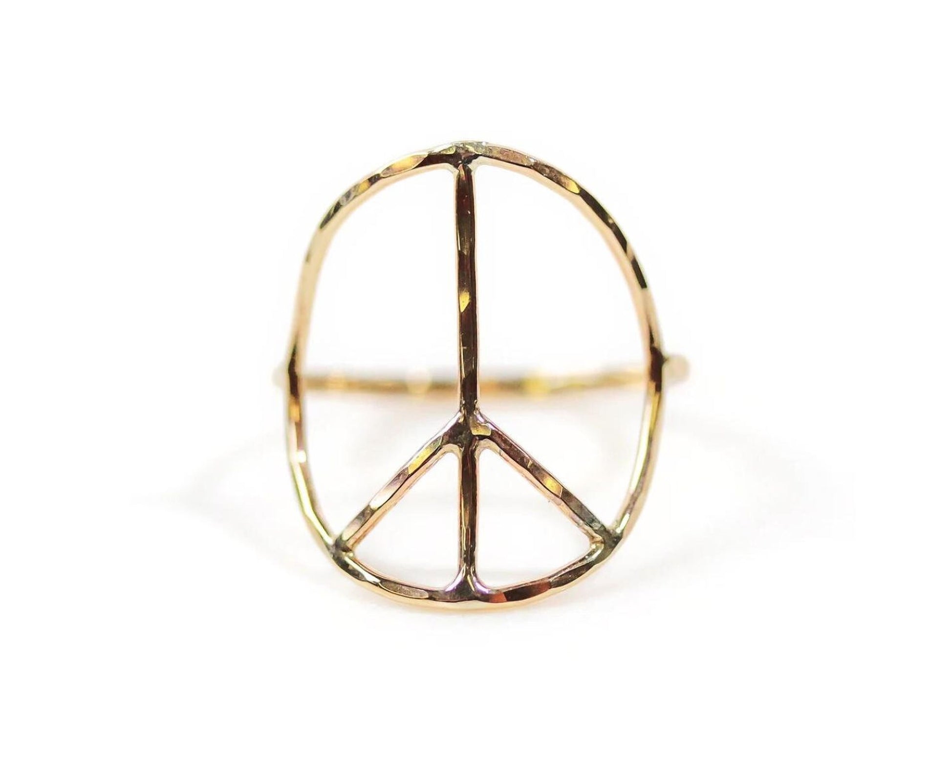 A gold ring in the shape of a peace symbol.