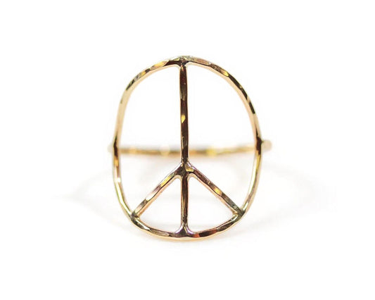 A gold ring in the shape of a peace symbol.