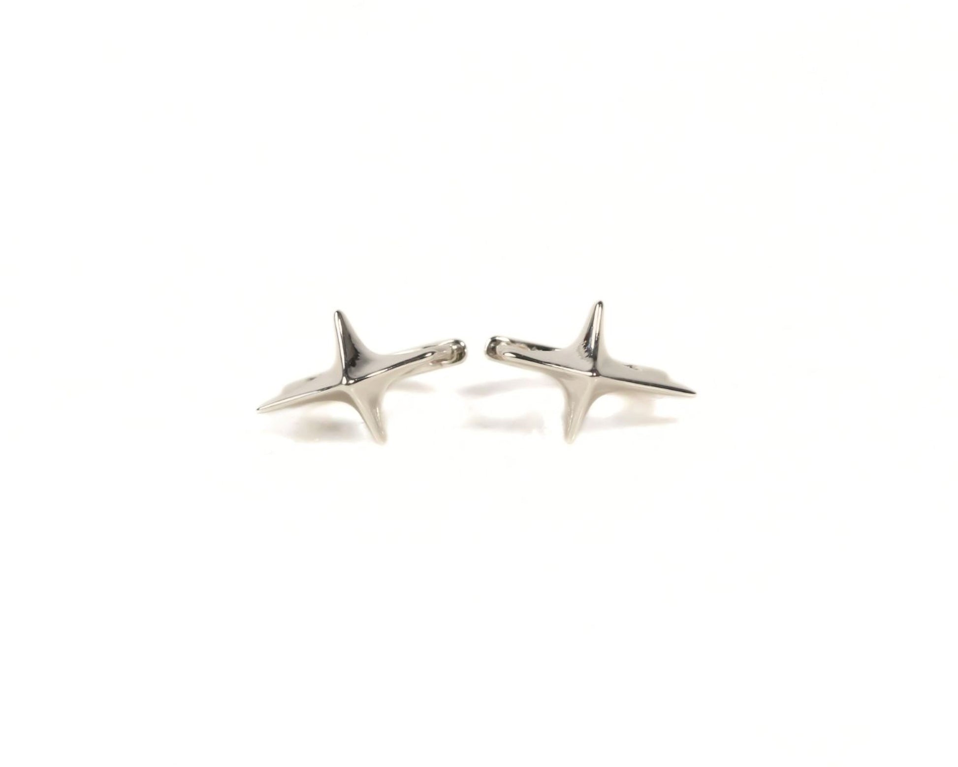 Two silver star-shaped earrings are shown against a white background.