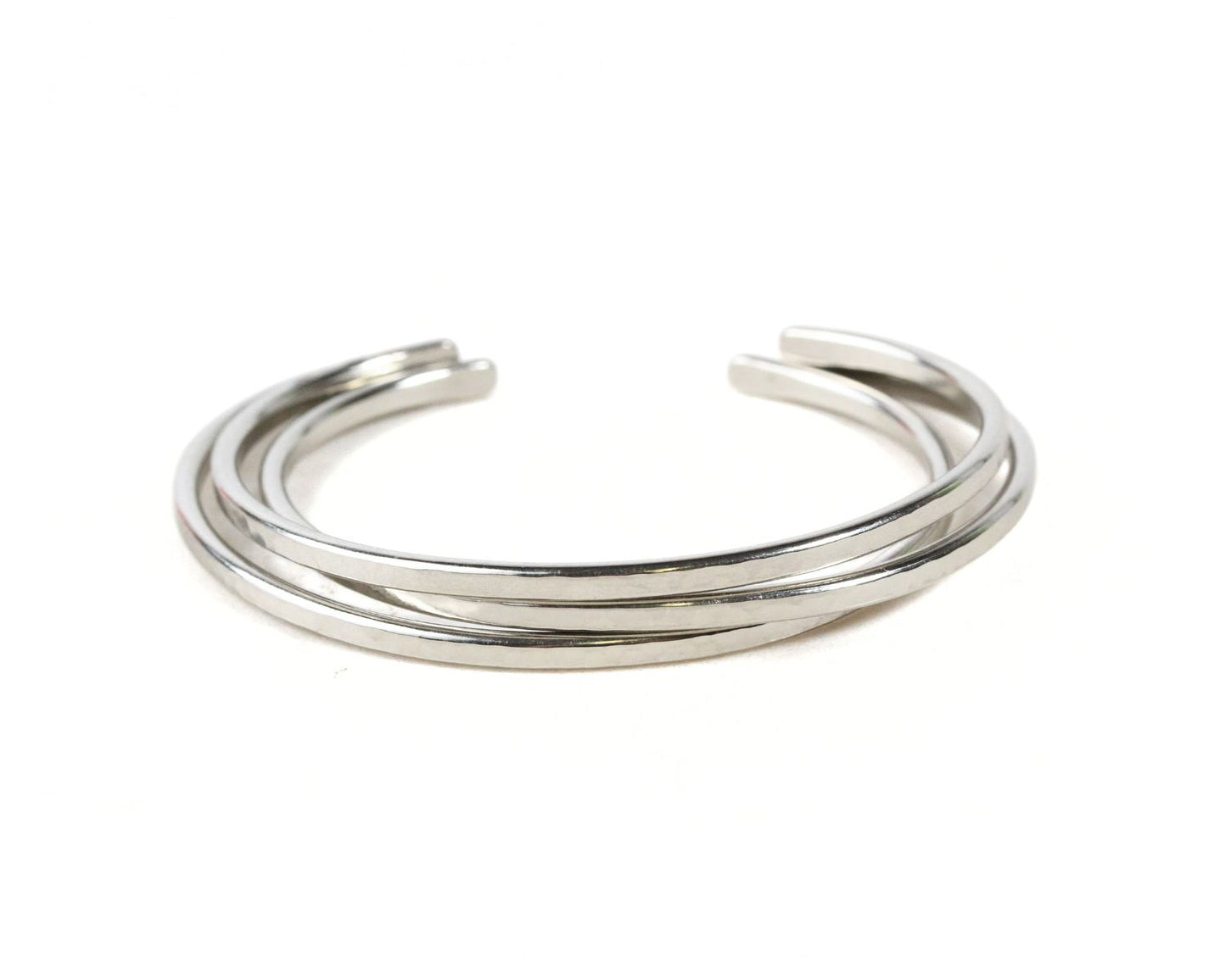 A silver bracelet with three interlocking bands.