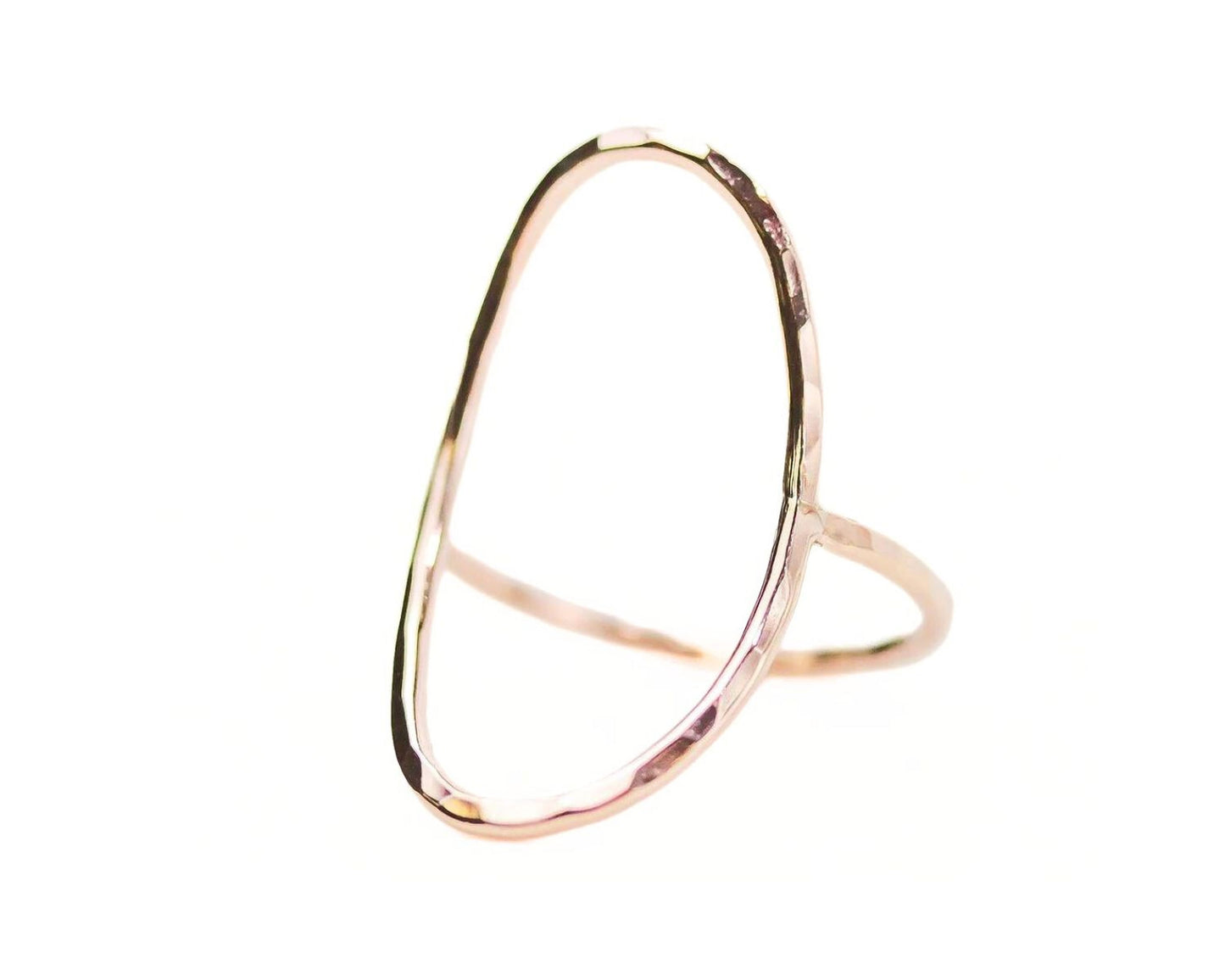 A gold-colored ring with a unique, irregular shape resembling a crescent moon or an oval.