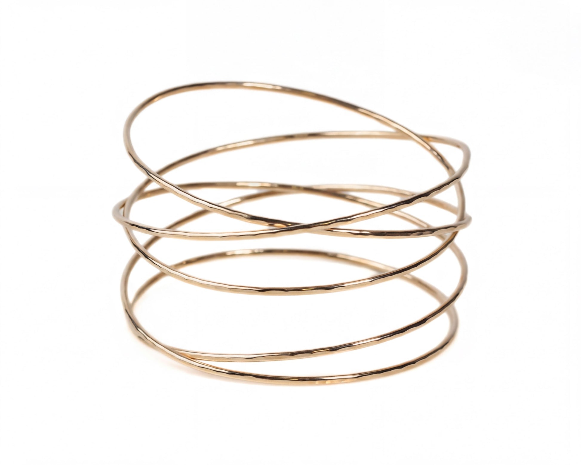 A gold-colored bracelet with multiple overlapping rings, creating a spiral-like design.