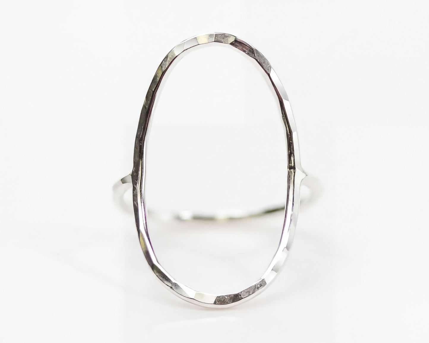 A silver ring with a unique oval shape.