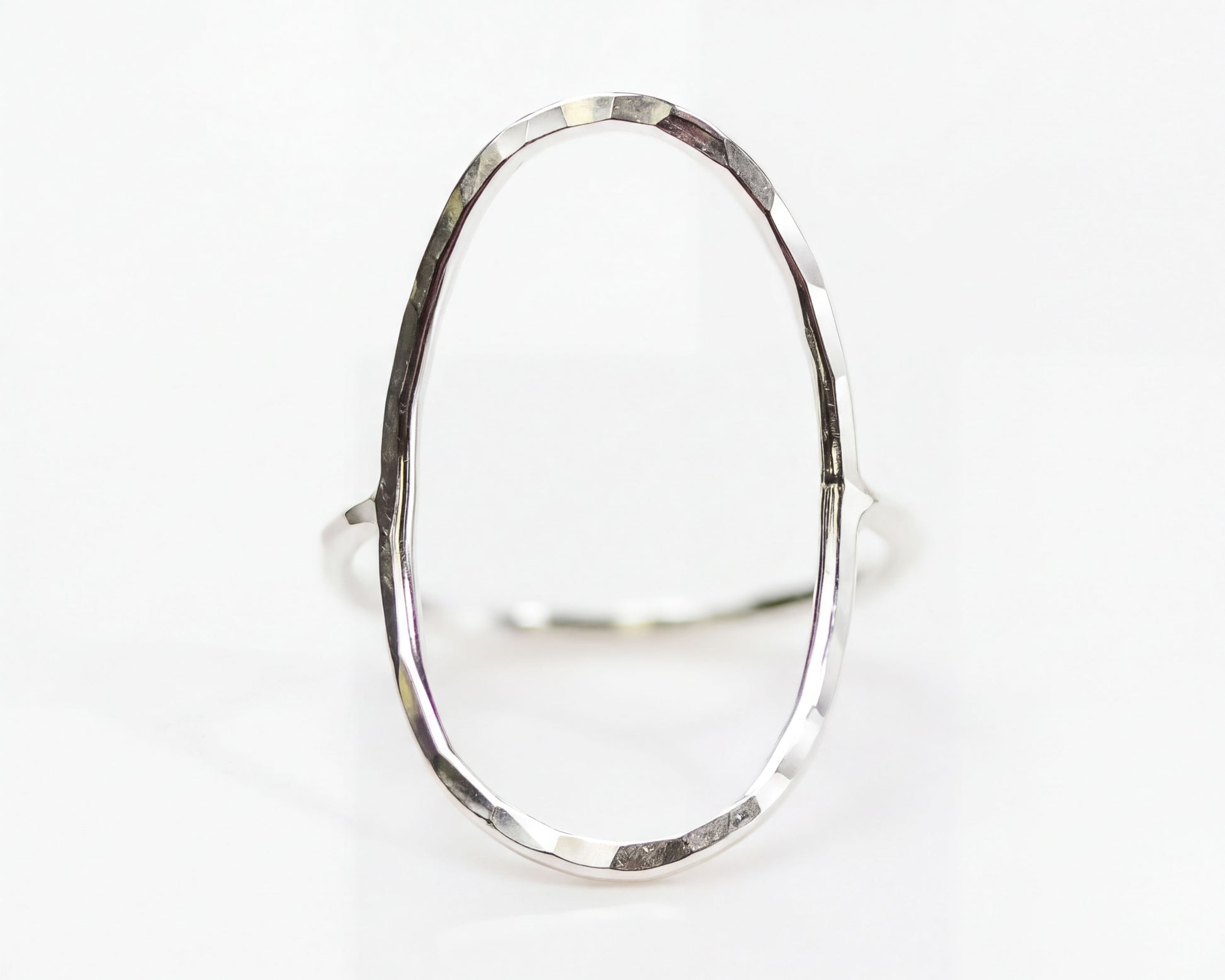 A silver ring with a unique oval shape.