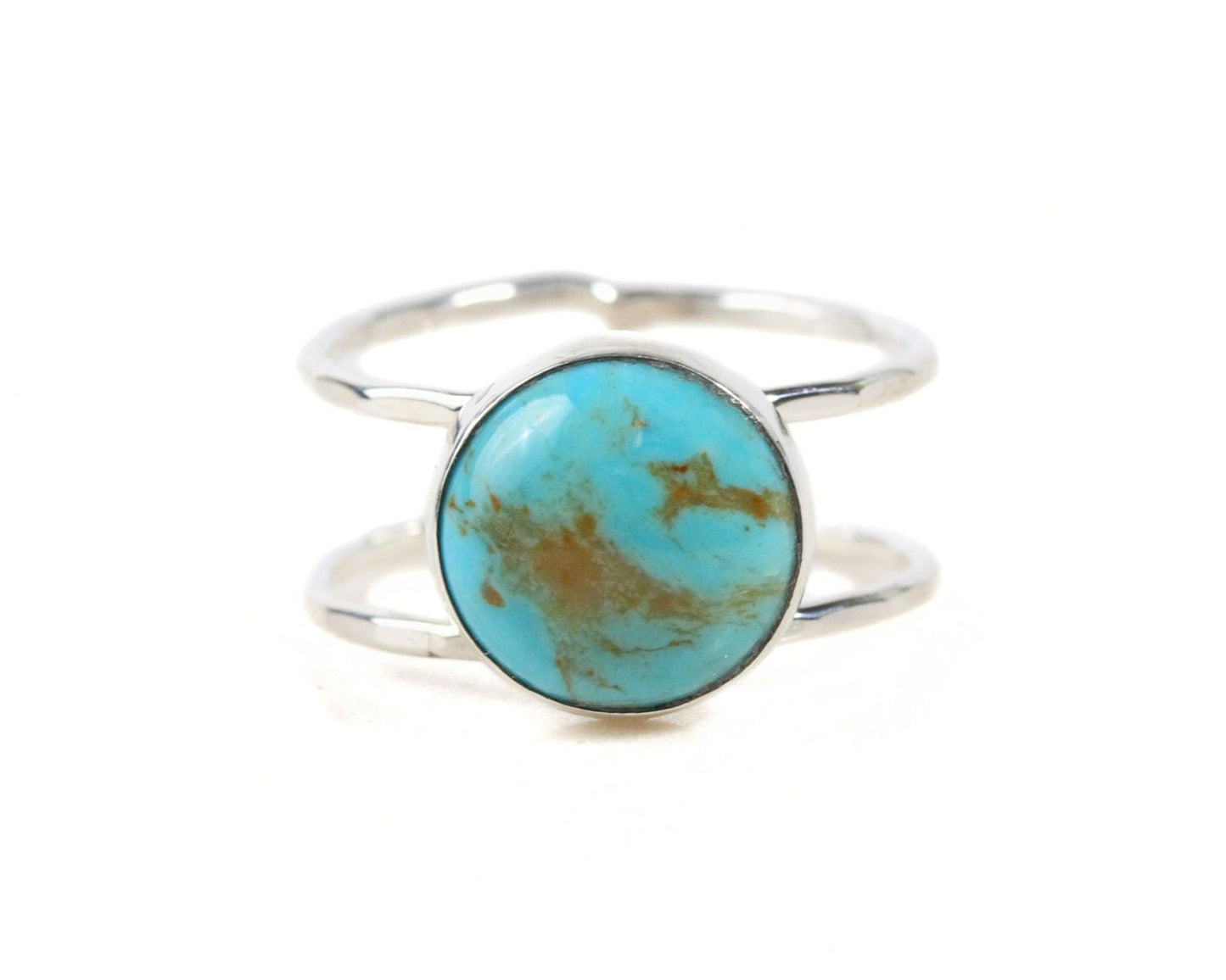 A silver ring with a turquoise stone in the center.