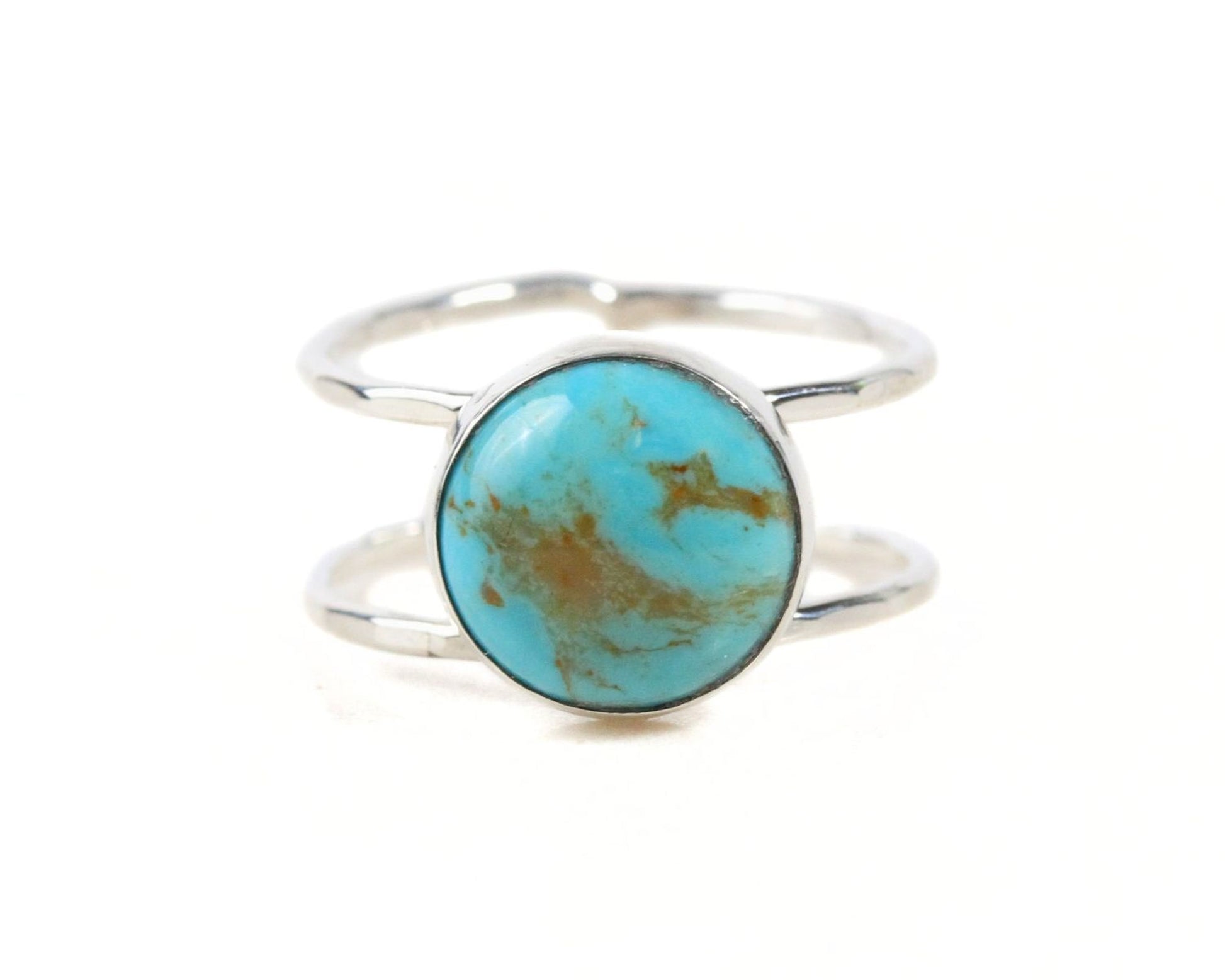 A silver ring with a turquoise stone in the center.