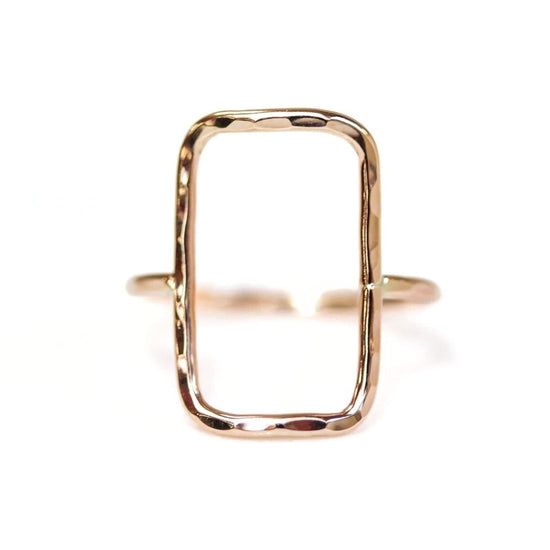 A gold ring with a rectangular cutout in the center.