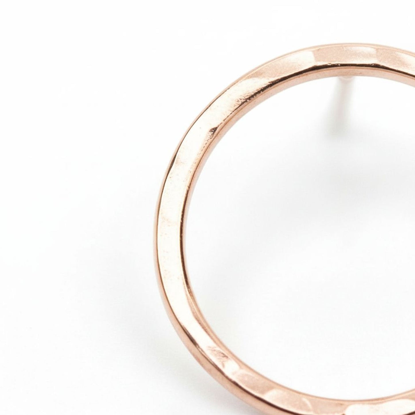 A close-up view of a shiny, metallic ring or bracelet against a plain white background.