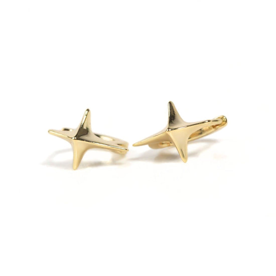 two gold star-shaped earrings with pointed tips.