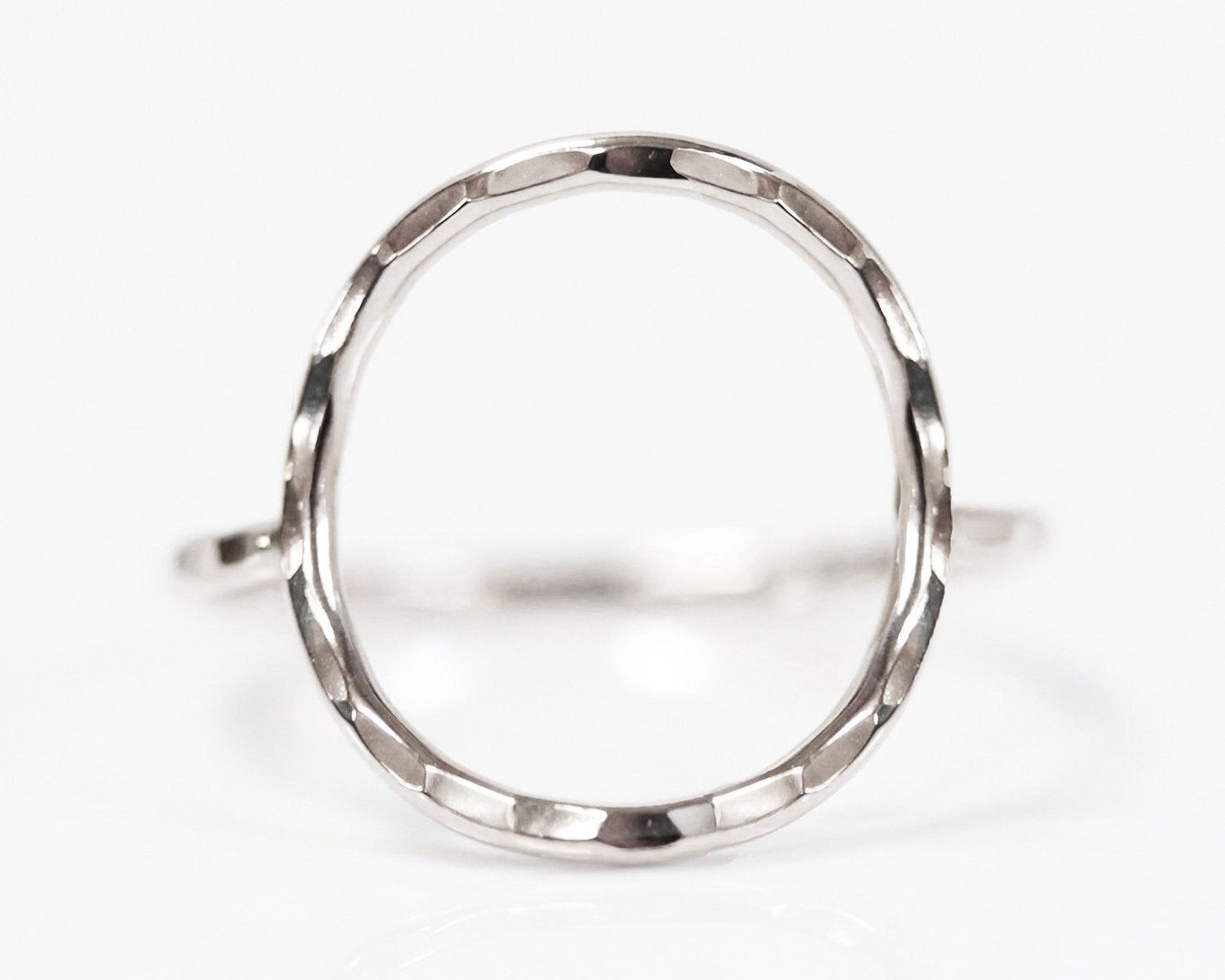 A silver ring with a unique, textured design.
