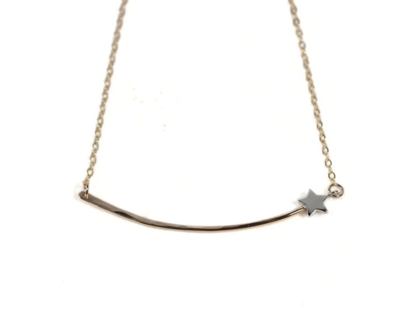A delicate necklace with a curved bar and a small star charm.