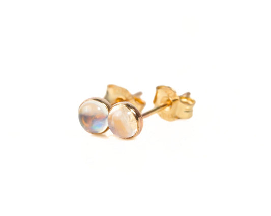 A pair of gold earrings with small, round stones in the center.