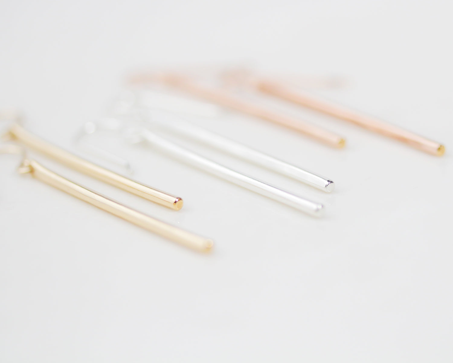 Side view of our long, slender and sleek earrings showcases the fine quality of the design. Showing all three fine metal selects and the precision by which they were made by hand.