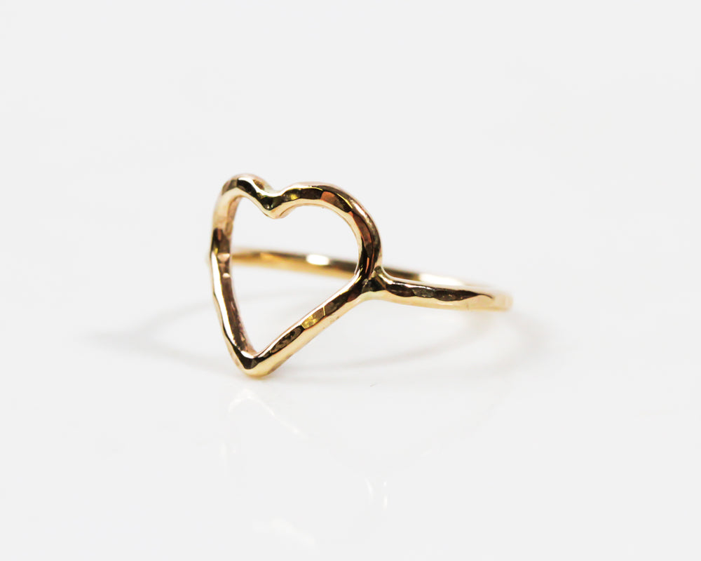 Image shows close up of our mini heart ring in 14 karat gold filled. This mini ring can be worn on your pinky, toe or as a midi ring. Perfect for Valentines Day or a gift of love to oneself. Offered in all three fine metal selects.