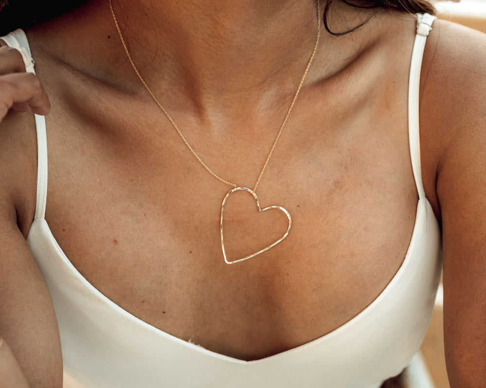 Exquisitely handcrafted with elevated materials, this unique open heart necklace will make the perfect gift for her! Our design is delightfully asymmetrical. Shown here in 14 karat yellow gold filled, it is sure to sweep her off her feet.